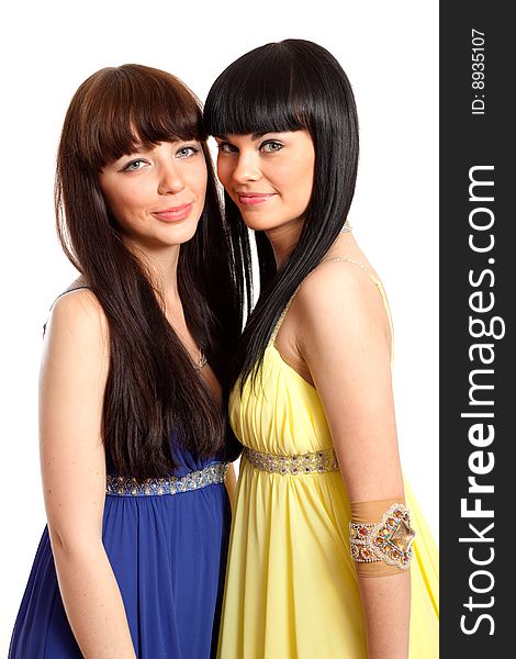 Two brunette woman in same blue and yellow dresses. Two brunette woman in same blue and yellow dresses