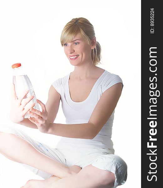 The girl of a sports kind with a bottle of water in a hand. The girl of a sports kind with a bottle of water in a hand