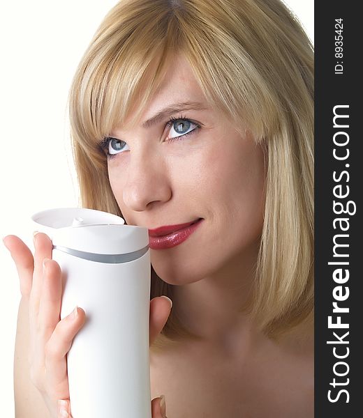 The beautiful girl with a cosmetics jar in a hand