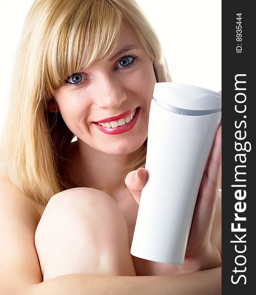 The beautiful girl with a cosmetics jar in a hand