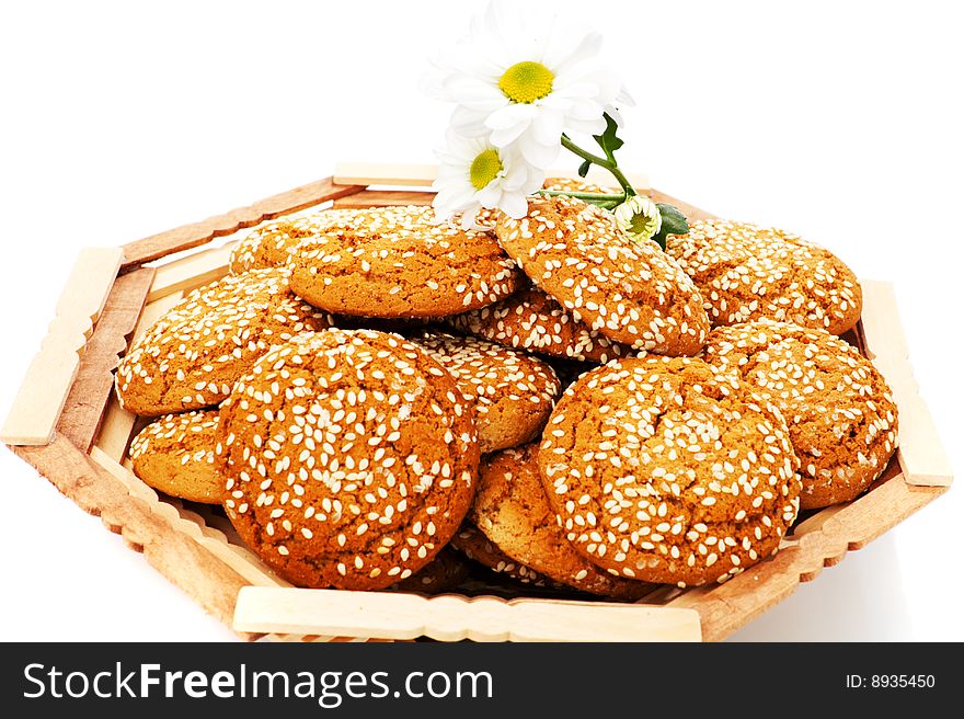 Cookies in wooden vase and chamomile