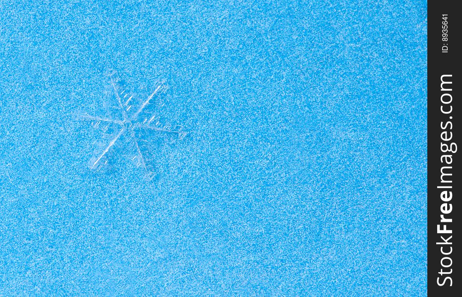 Snowflake on blue macro shot