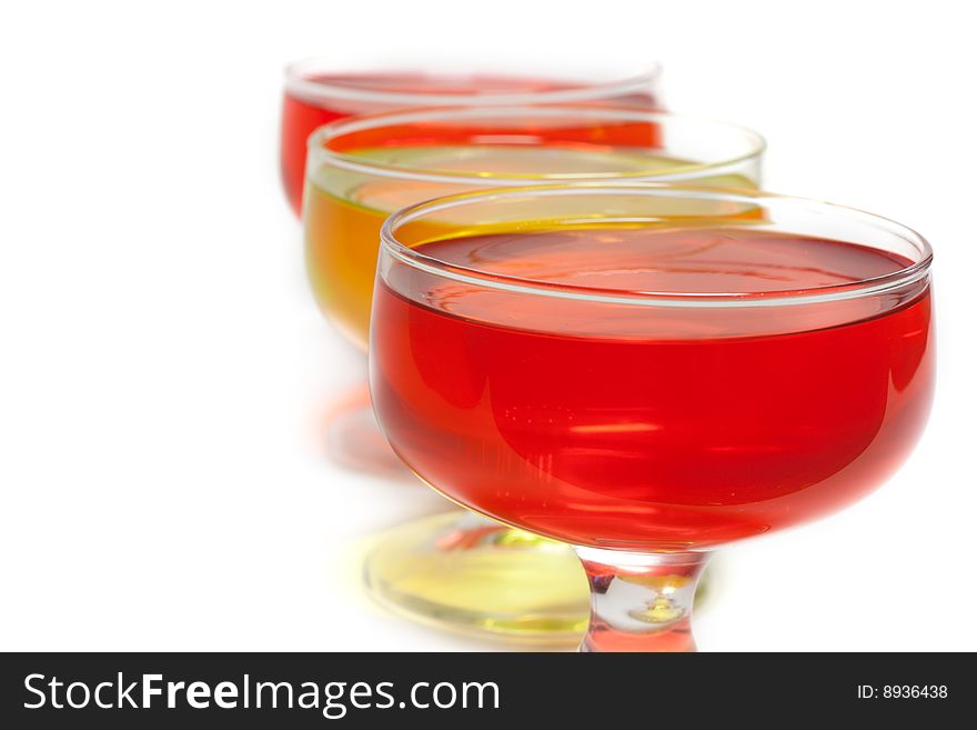 Yellow, red jelly in transparent glass stand on white background inline. Yellow, red jelly in transparent glass stand on white background inline