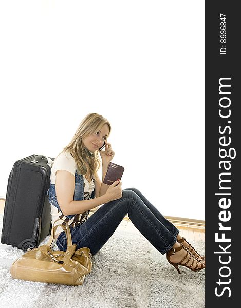 Beautiful woman talking on her mobile before her trip. Beautiful woman talking on her mobile before her trip