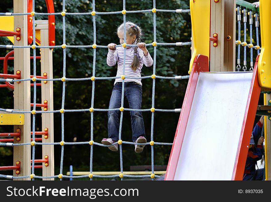 Girl plays on baby platform in park