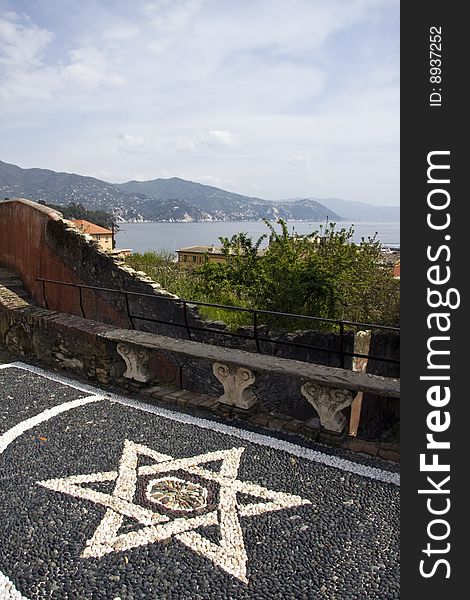 Landscape of Italian Riviera and a mosaic star to the fore