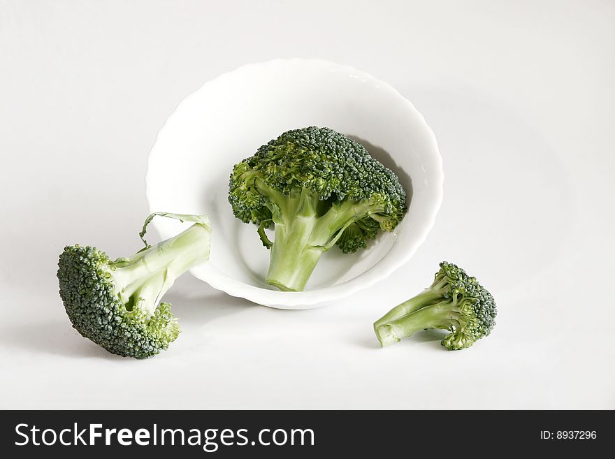 Fresh green broccoli and white plate