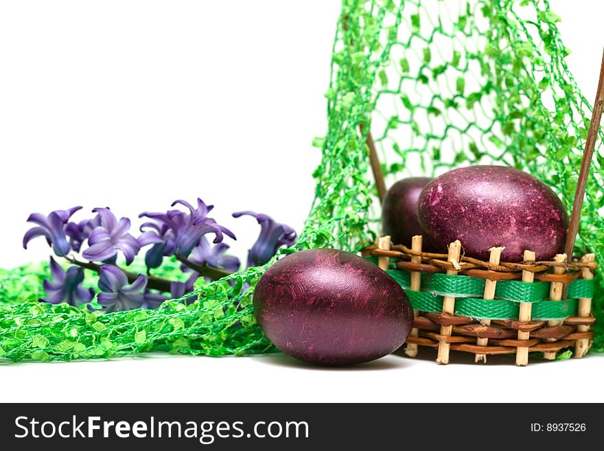 Easter eggs with spring flowers in a basket