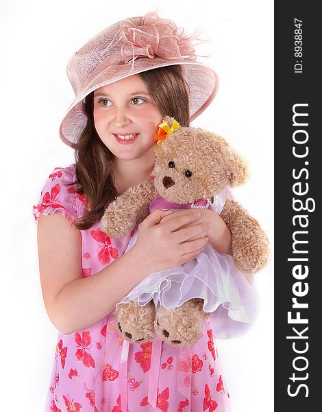 Girl in pink hat and dress with her teddy. Girl in pink hat and dress with her teddy