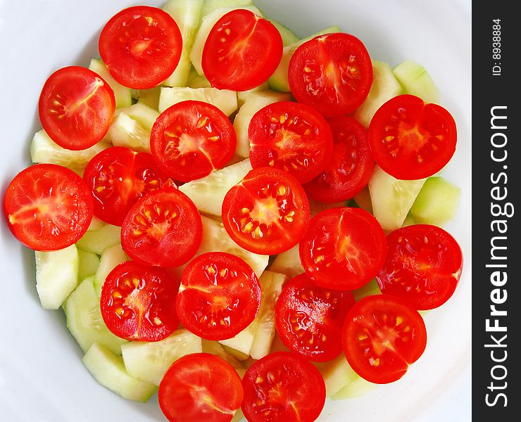 Red fresh cherry tomatoes salad with cucumbers