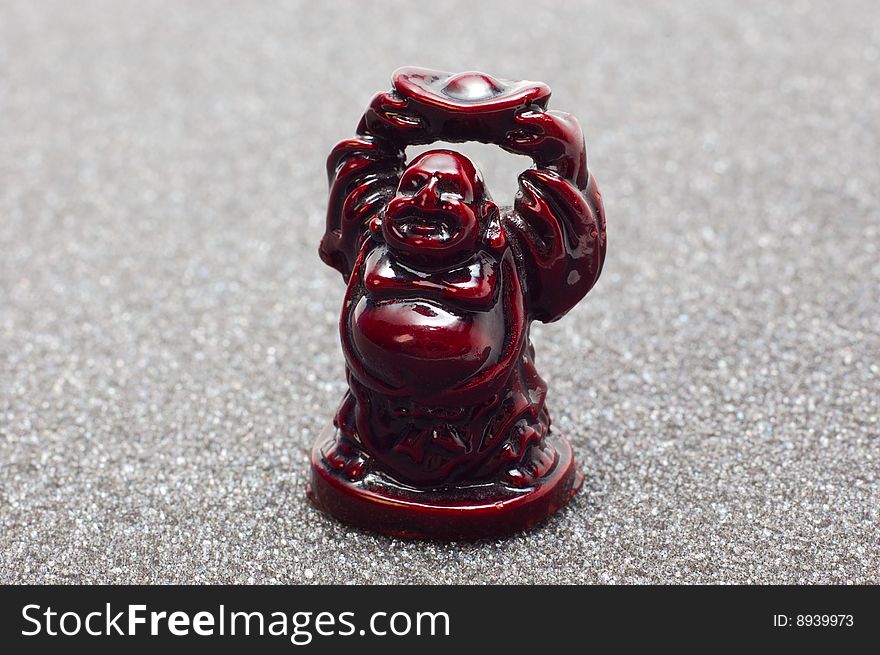 Netsuke - small idol (buddha) isolated on grey. Netsuke - small idol (buddha) isolated on grey