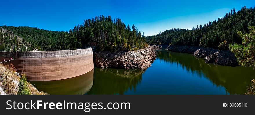 Craigin Dam and Reservoir with clear water, rocks and forest surroundings, cloudless blue sky. Craigin Dam and Reservoir with clear water, rocks and forest surroundings, cloudless blue sky.