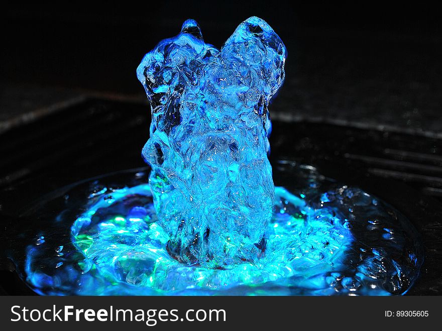 A fountain with blue lights bubbling. A fountain with blue lights bubbling.