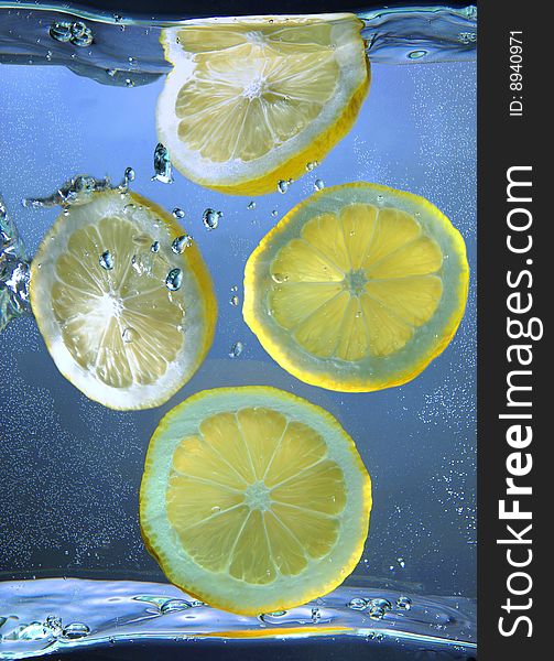 Lemon segments falling in water