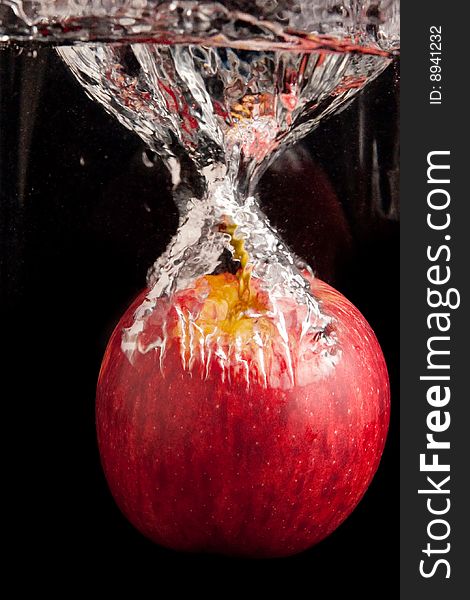 Fresh red apple diving in water. Fresh red apple diving in water