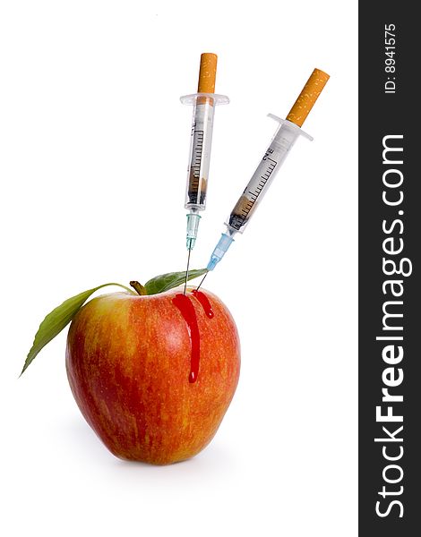 Cigarette syringe in apple on white background. Cigarette syringe in apple on white background