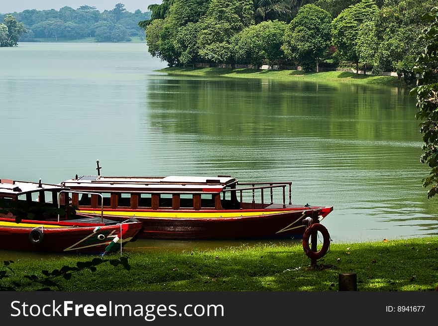 Lakeside with boats parking in green background. Lakeside with boats parking in green background