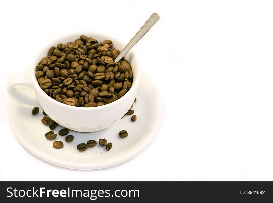 Cup with coffee beans and teaspoon. Cup with coffee beans and teaspoon