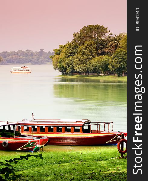 Lakeside with boats parking in green background. Lakeside with boats parking in green background