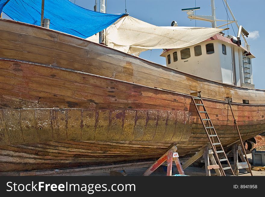 An old fishing boat under going maintenance on the island of Tenerife. An old fishing boat under going maintenance on the island of Tenerife