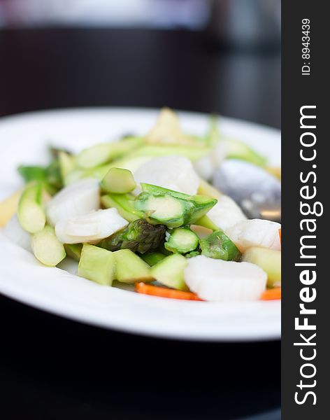Delicious Chinese seafood dish in white plate. Delicious Chinese seafood dish in white plate