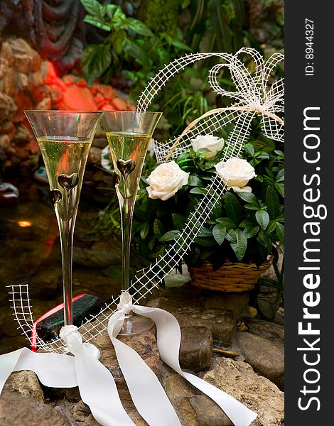 Wedding composition with glasses, champagne and flowers