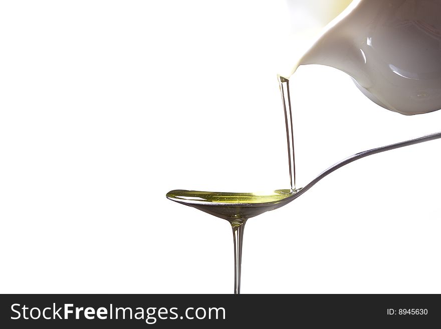 Olive oil poured  into a spoon
