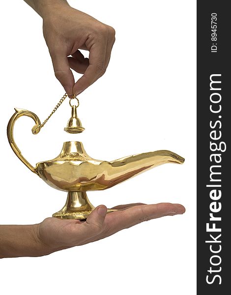 An arabic magic lamp on a persons hand, isolated on white. An arabic magic lamp on a persons hand, isolated on white.