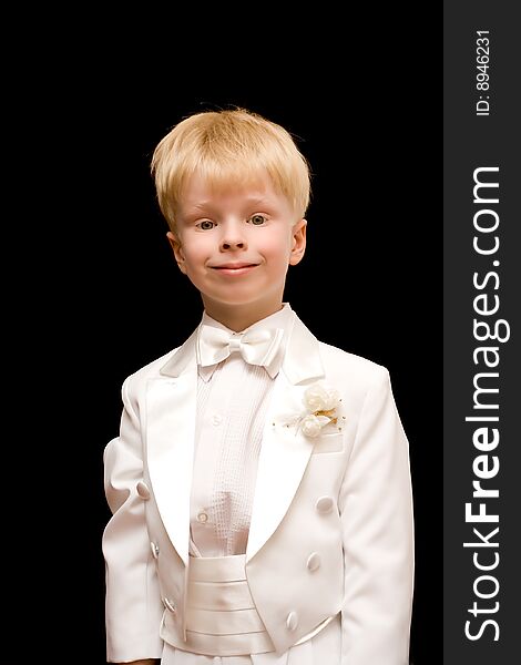 The child in a white tuxedo on a black background
