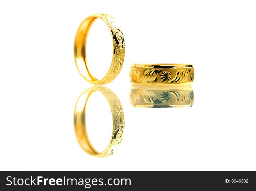 Two golden rings standing on white background.