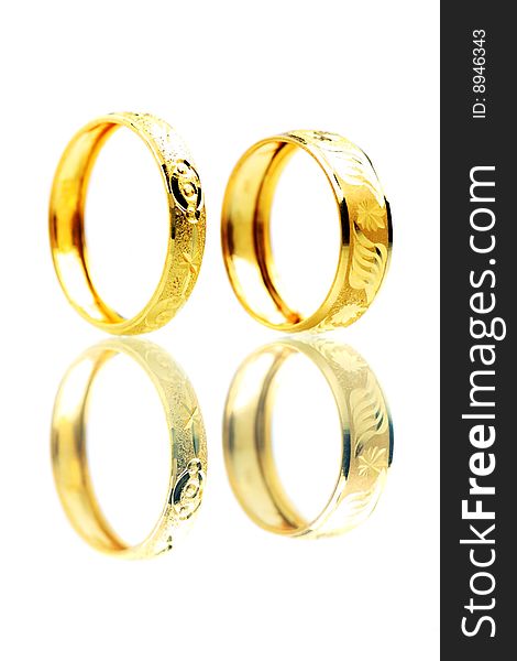 Two golden rings standing on white background.