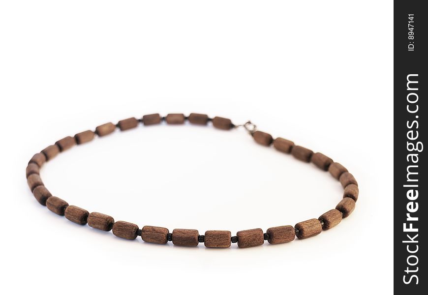 Simple wooden necklace, white background, brown beads