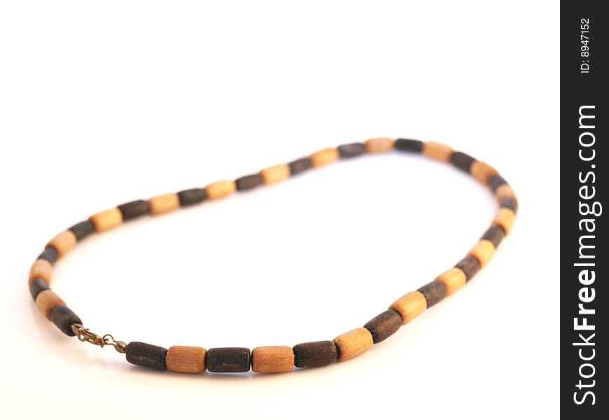 Simple wooden necklace, white background, black and light beads. Simple wooden necklace, white background, black and light beads