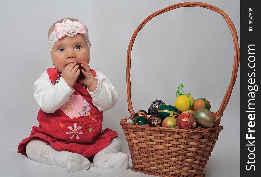 Little girl with basket and Easter eggs