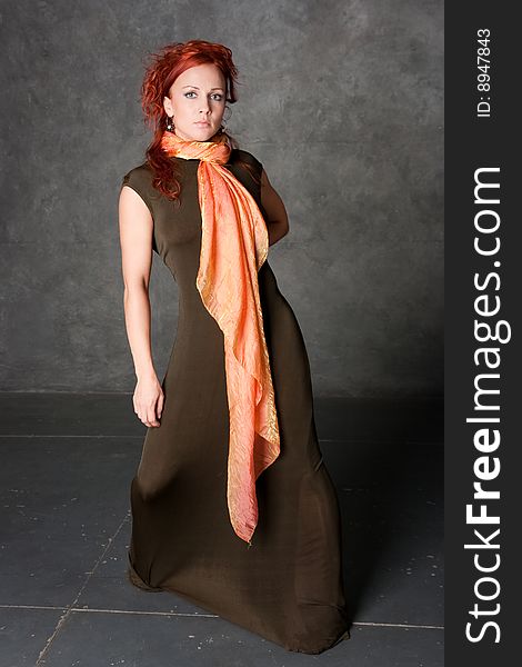 The girl in a long dress with an orange scarf
