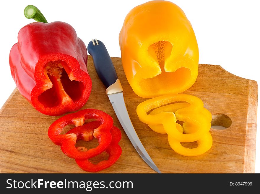 Red and yellow sweet pepper lays on a chopping board. Red and yellow sweet pepper lays on a chopping board