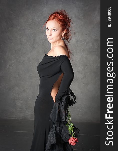 The beautiful girl with a red rose