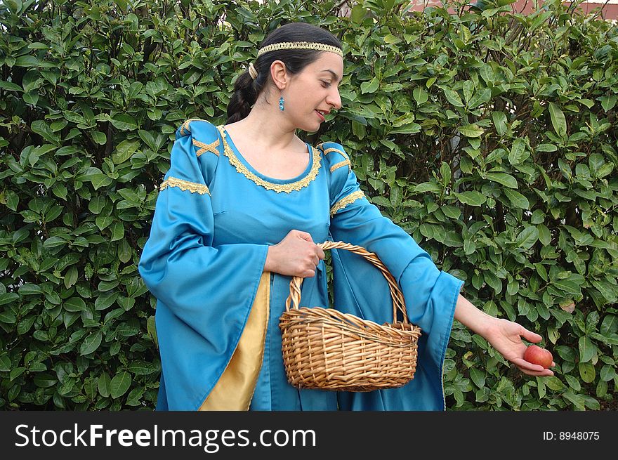 Medieval lady offering red apples