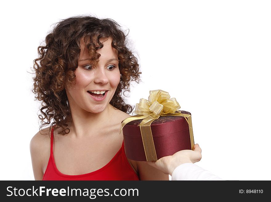 Beautiful woman with a gift. Attractive girl holding purple box with gold ribbon. Woman is surprising at present. Isolated over white background. Beautiful woman with a gift. Attractive girl holding purple box with gold ribbon. Woman is surprising at present. Isolated over white background.