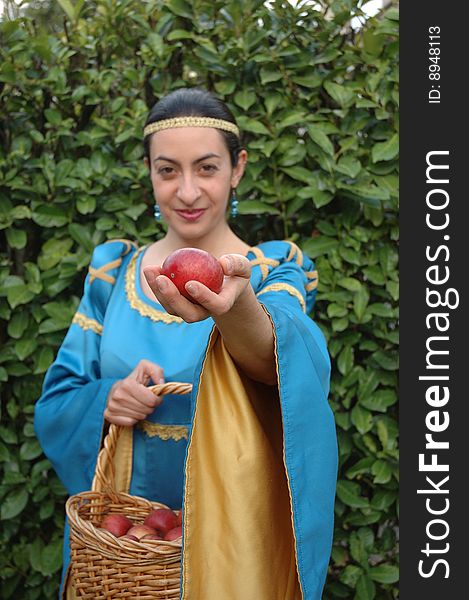 Medieval lady offering red apples