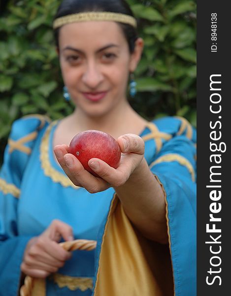 Medieval lady offering red apples