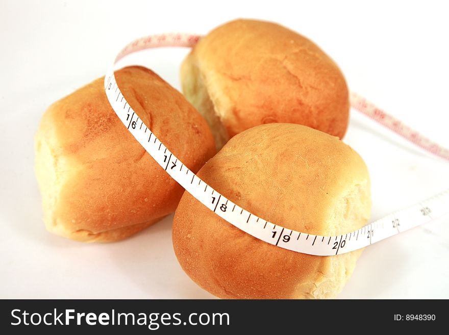 An image of dinner rolls with tape measure. An image of dinner rolls with tape measure