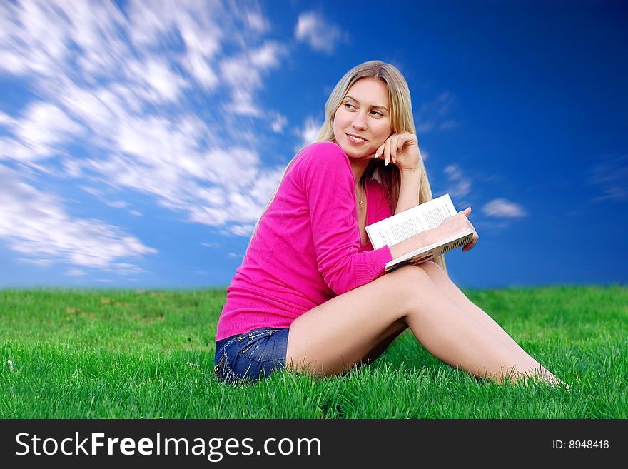 Beautiful Girl With Book On The Green Grass