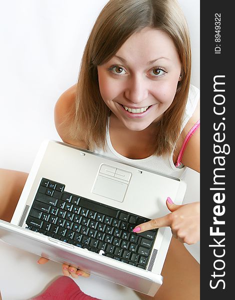 Beautiful female student relaxing with her laptop.