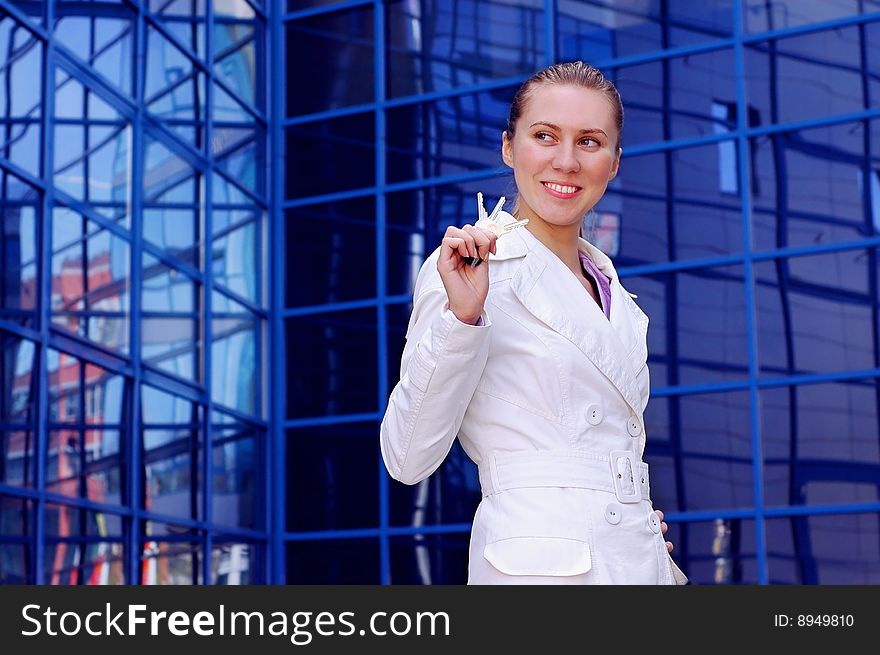 Business women in white on business architecture background. Business women in white on business architecture background