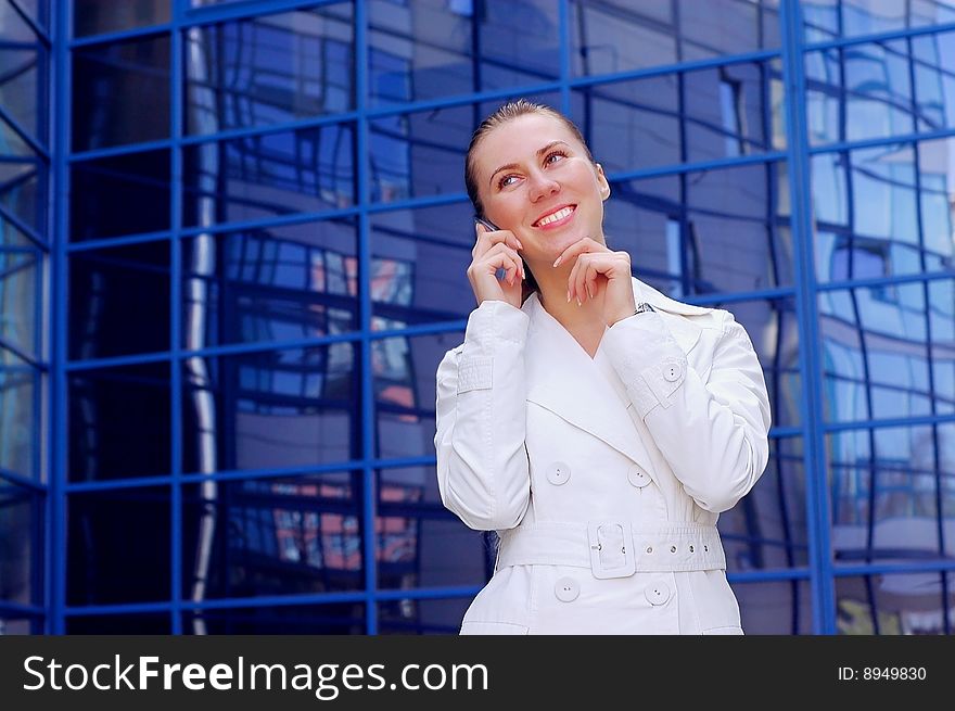 Business women in white on business architecture background. Business women in white on business architecture background