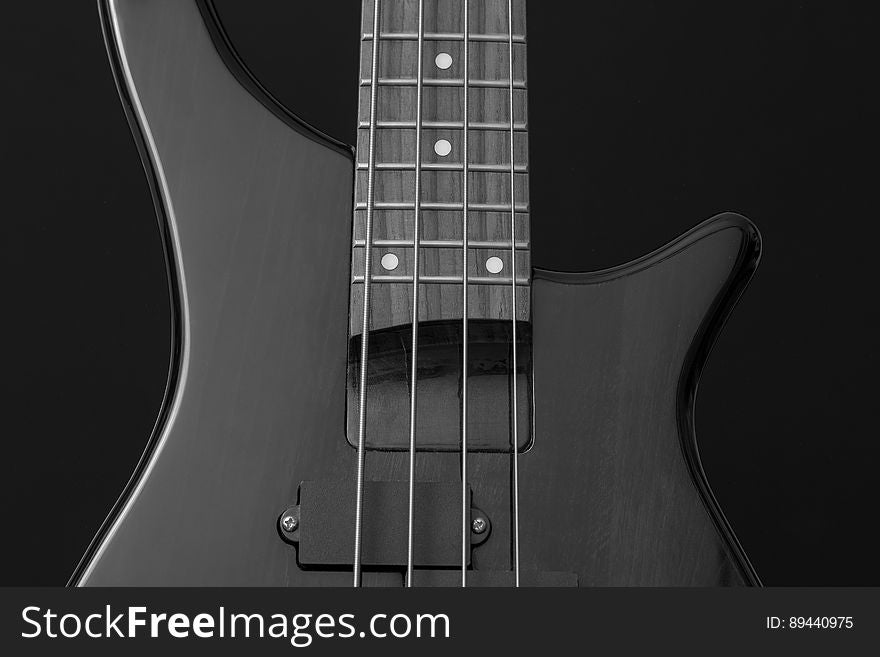 Close Up Photo of Gray Electric Bass Guitar