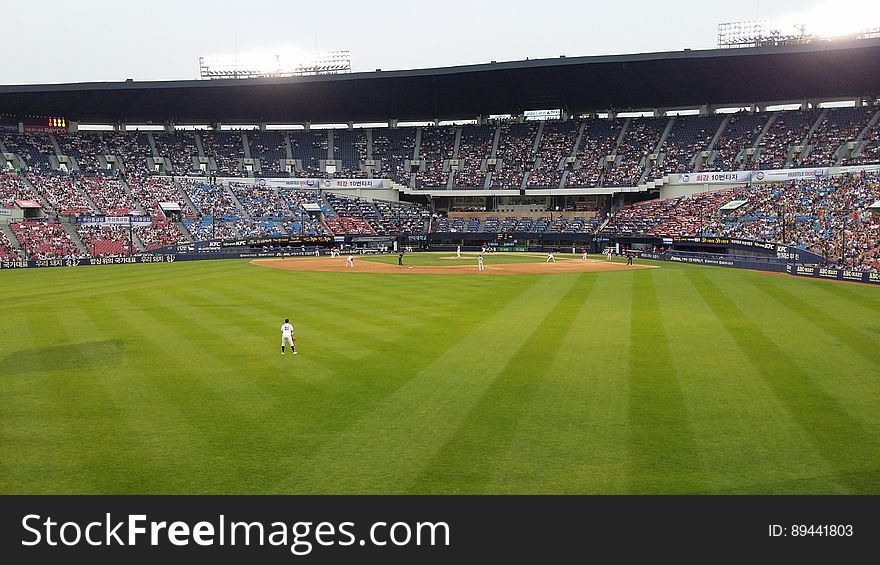 Players on stadium diamond during professional baseball game.