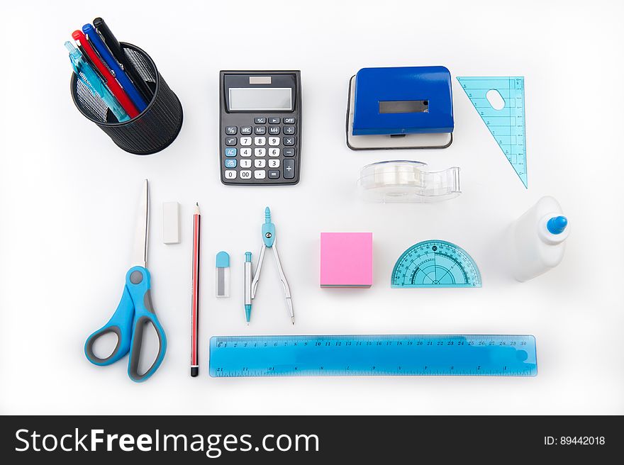 A desk with office supplies and drawing tools.