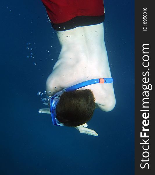 Young men dive in blue sea with bubbles. Young men dive in blue sea with bubbles